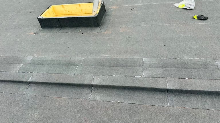 Flat roof with black pipe, yellow container, and scattered debris on gray surface