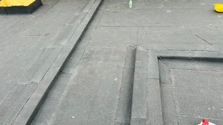 Close-up of concrete floor with grooves and seams, showing construction or industrial surface detail